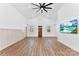 Bright living room featuring a vaulted ceiling, modern ceiling fan, and stylish flooring at 3409 Dallas High Shoals Hwy, Dallas, NC 28034