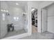 Bright bathroom featuring a glass shower and a peek into a well-organized walk-in closet at 343 Embers Ln, Clover, SC 29710