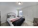 Cozy bedroom with neutral walls, a wrought-iron bed frame, and a window providing natural light at 343 Embers Ln, Clover, SC 29710