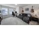 Upstairs bonus room with gray sofa, desk and chair and natural light from a window at 343 Embers Ln, Clover, SC 29710