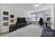 Bonus room featuring large TV, sleek furniture, and lots of natural light from the windows at 343 Embers Ln, Clover, SC 29710