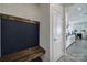 Inviting entryway with a wooden bench, chalkboard accent wall, and a view into the open-concept living space at 343 Embers Ln, Clover, SC 29710