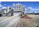 Charming two-story home with a two-car garage, manicured landscaping, and a welcoming entryway at 343 Embers Ln, Clover, SC 29710