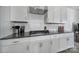 Close-up view of the modern kitchen featuring granite countertops, subway tile backsplash, and a stainless steel range hood at 343 Embers Ln, Clover, SC 29710