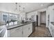 Bright kitchen features a large granite island, stainless steel appliances, and a view into the dining area at 343 Embers Ln, Clover, SC 29710