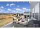 A patio with outdoor seating, with a view of the lawn and neighborhood beyond at 343 Embers Ln, Clover, SC 29710