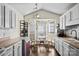 Sunlit kitchen featuring white cabinets, a breakfast nook with a bay window, and modern appliances at 3507 Southern Ginger Dr, Indian Trail, NC 28079