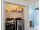 Laundry room with washer, dryer, storage shelves, and organized space; very tidy at 3507 Southern Ginger Dr, Indian Trail, NC 28079