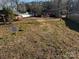 Large backyard with gravel driveway and mature trees at 518 Glenn St, Chester, SC 29706