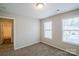 Well-lit bedroom with two windows and access to a bathroom at 6143 Raisin Tree Ln, Charlotte, NC 28215