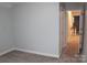 A carpeted bedroom with a door leading to the hallway at 622 Oakdale Dr, Statesville, NC 28677