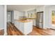 Bright kitchen featuring an island, modern appliances, white cabinetry and hardwood floors at 622 Oakdale Dr, Statesville, NC 28677