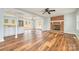 Open living room with a brick fireplace, wood floors, and stainless steel appliances visible at 622 Oakdale Dr, Statesville, NC 28677