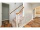 Carpeted staircase with wooden handrail and neutral walls, leading to the upper level at 622 Oakdale Dr, Statesville, NC 28677