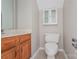 Small bathroom with wood cabinets and updated toilet at 637 Tysons Forest Dr, Rock Hill, SC 29732