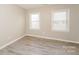 Bright bedroom with hardwood floors and two windows at 637 Tysons Forest Dr, Rock Hill, SC 29732