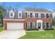Brick house with a two-car garage and landscaped lawn at 637 Tysons Forest Dr, Rock Hill, SC 29732