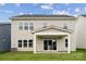 Two-story home featuring a spacious backyard, covered patio, and sliding glass doors at 7120 Wayfarer Dr # 0079, Charlotte, NC 28269