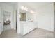 Modern bathroom featuring a large mirror, double vanity, tile floors and a walk-in shower at 7120 Wayfarer Dr # 0079, Charlotte, NC 28269