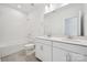Bright bathroom featuring a dual sink vanity, white tile, and a combined tub and shower at 7120 Wayfarer Dr # 0079, Charlotte, NC 28269