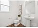 Bathroom featuring tile floors, white fixtures, and framed art at 7120 Wayfarer Dr # 0079, Charlotte, NC 28269