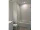Bathroom with a shower-tub combo, tile surround, and modern fixtures at 7120 Wayfarer Dr # 0079, Charlotte, NC 28269
