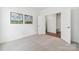 Bright bedroom featuring neutral carpet, white walls, and an ensuite closet at 7120 Wayfarer Dr # 0079, Charlotte, NC 28269