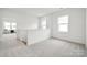 Hallway with neutral carpet, white walls, natural light, and views of the home's interior at 7120 Wayfarer Dr # 0079, Charlotte, NC 28269