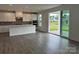 Modern kitchen with an island, stainless steel appliances, and a sliding glass door to the patio at 7120 Wayfarer Dr # 0079, Charlotte, NC 28269