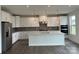 Modern kitchen featuring white cabinetry, stainless steel appliances, a center island and stylish pendant lighting at 7120 Wayfarer Dr # 0079, Charlotte, NC 28269