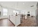 Expansive space showcases an open layout with a kitchen island, dining area, and fireplace living room at 7120 Wayfarer Dr # 0079, Charlotte, NC 28269