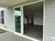 Spacious living room featuring a sliding glass door and luxury vinyl plank (LVP) flooring at 7120 Wayfarer Dr # 0079, Charlotte, NC 28269