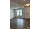 Bright, neutral living room featuring a fireplace, large windows, and wood-look floors at 7120 Wayfarer Dr # 0079, Charlotte, NC 28269