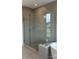 Modern bathroom with a glass-enclosed shower and a soaking tub at 7120 Wayfarer Dr # 0079, Charlotte, NC 28269
