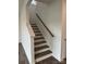 Staircase features wooden stairs and railing and white risers and stringer at 7120 Wayfarer Dr # 0079, Charlotte, NC 28269