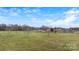 Aerial shot capturing the home nestled on a spacious lot with mature trees and a wide expanse of green space at 760 Tomlin Mill Rd, Statesville, NC 28625