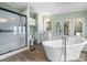 Bathroom with soaking tub, shower, toilet, and vanity featuring modern fixtures and wood look floors at 760 Tomlin Mill Rd, Statesville, NC 28625