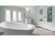 Bathroom features a freestanding tub and a vanity area with multiple windows for bright, natural lighting at 760 Tomlin Mill Rd, Statesville, NC 28625