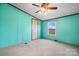This bedroom features bright turquoise walls and a window allowing for lots of natural light at 760 Tomlin Mill Rd, Statesville, NC 28625