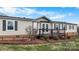 Charming home featuring a cozy front porch and fresh landscaping at 760 Tomlin Mill Rd, Statesville, NC 28625