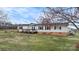 Front of home showing a cozy deck with landscaping and a spacious front yard at 760 Tomlin Mill Rd, Statesville, NC 28625