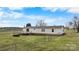 Rear exterior of the ranch-style home with a deck and fenced yard, set on a grassy lot at 760 Tomlin Mill Rd, Statesville, NC 28625