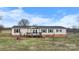Charming ranch style home with a covered front porch and well-maintained landscaping at 760 Tomlin Mill Rd, Statesville, NC 28625