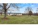 A well-maintained home featuring a cozy front porch, complemented by a verdant lawn and mature trees at 760 Tomlin Mill Rd, Statesville, NC 28625