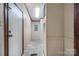 The hallway features neutral walls, a tile floor, and a bright overhead light at 760 Tomlin Mill Rd, Statesville, NC 28625