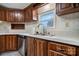 Bright kitchen with a stainless steel sink, white countertop, wooden cabinets and an open layout at 760 Tomlin Mill Rd, Statesville, NC 28625