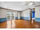 Inviting living area with gleaming wood floors, sliding glass door and a ceiling fan at 760 Tomlin Mill Rd, Statesville, NC 28625