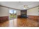 Cozy living room featuring a decorative fireplace, wood floors, and sliding glass door at 760 Tomlin Mill Rd, Statesville, NC 28625