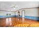 Bright living room featuring parquet floors, a ceiling fan, and neutral wall colors at 760 Tomlin Mill Rd, Statesville, NC 28625