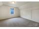 Bright bedroom with a window offering natural light and neutral carpeting at 9012 Blue Willow Ln, Charlotte, NC 28227